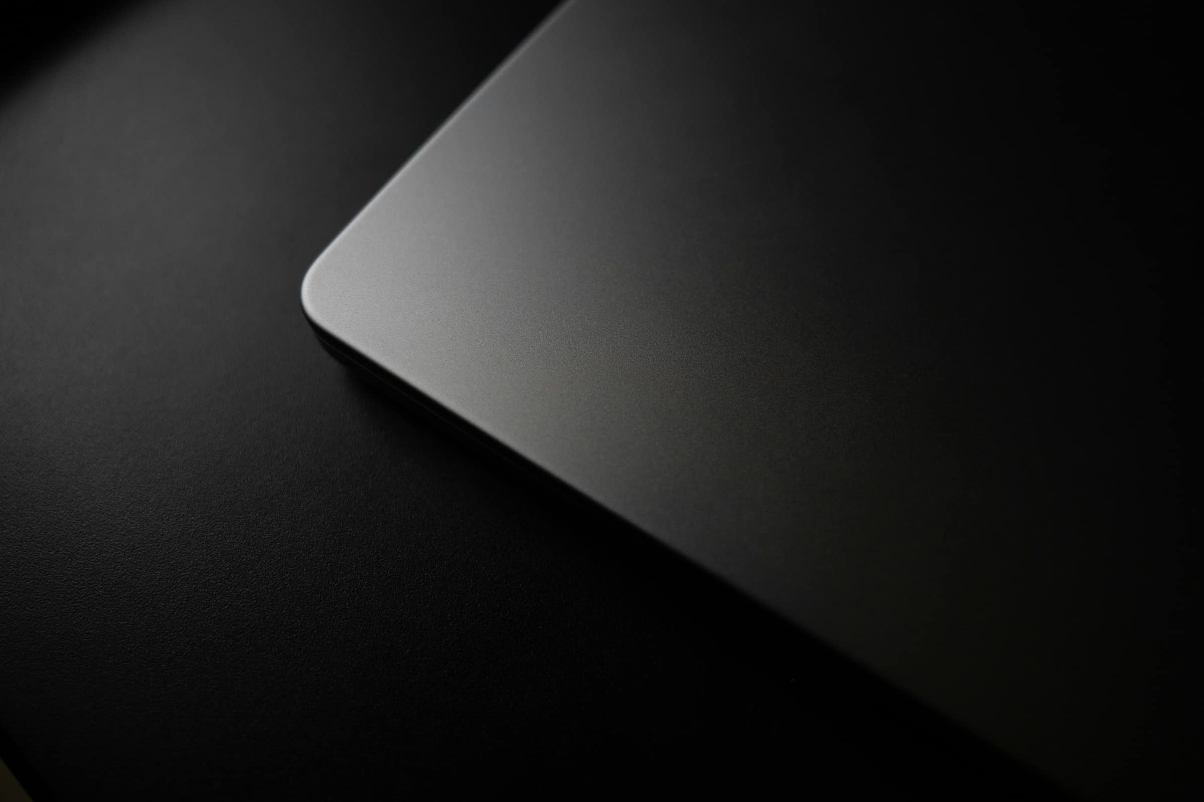 macro corner of a dark deskpad on black